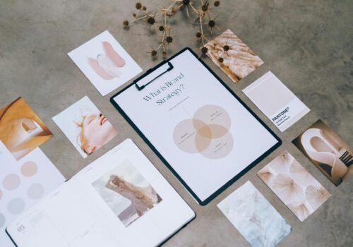 Flat lay of a minimalist brand strategy moodboard on a concrete surface.